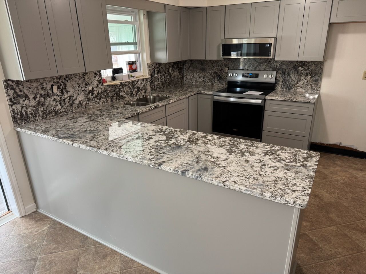 Granite kitchen counters with white cabinets